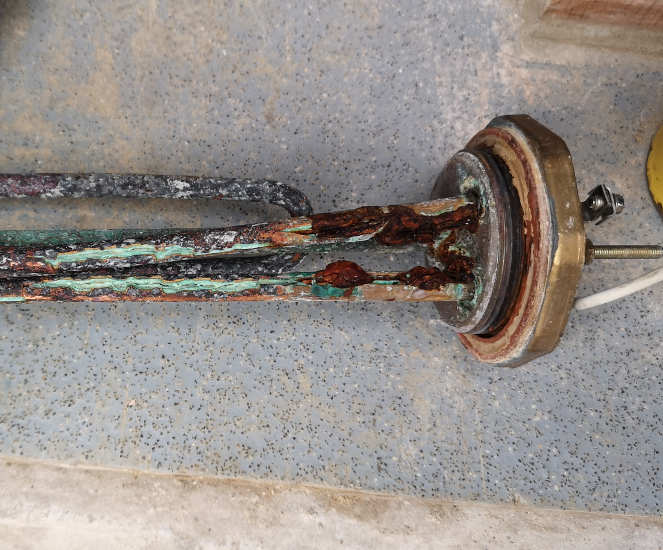Scaled and leaking immersion heater no longer heating water properly and needs replacing